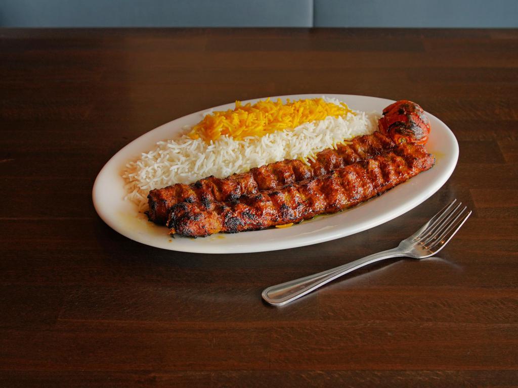 27. Chelo Kabob Koobideh · Two skewers of ground sirloin seasoned and mixed with grated onions and broiled on an open flame. Served with steamed basmati rice and BBQ tomato.