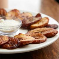 Tajadas · Sweet plantains with aged cheese. 