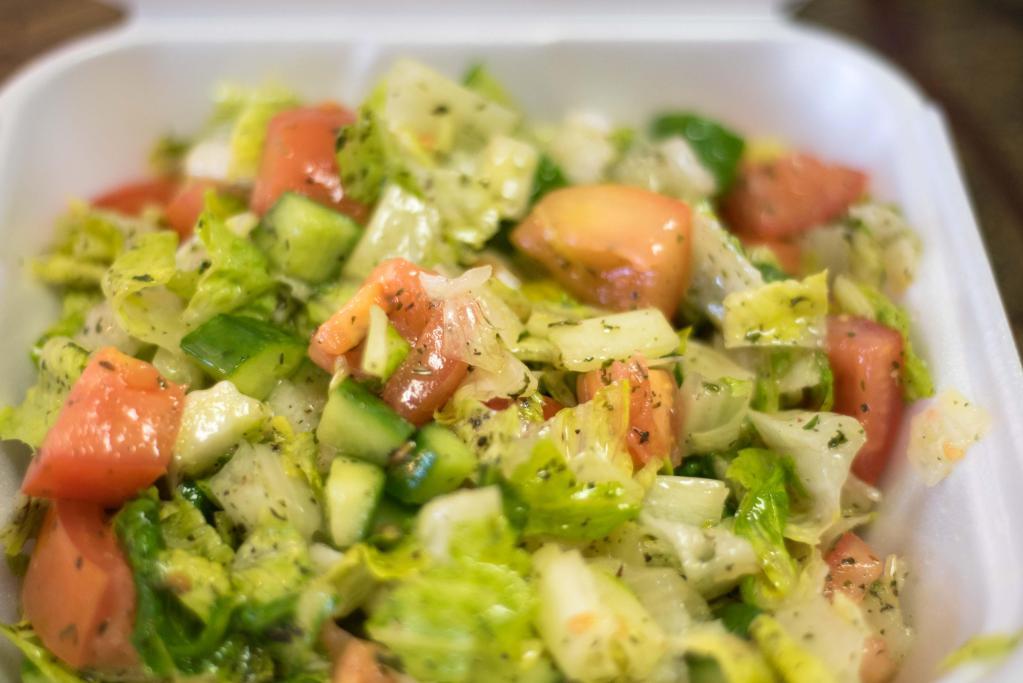 Green Salad سلطة خضراء · Lettuce, tomatoes, cucumber, green onion, carrot, and parsley. Seasoned with olive oil and lemon juice.
