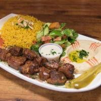 Lamb Kabob Plate · Cubes of lamb. Grilled and served with hummus, rice, salad and fresh bread.
