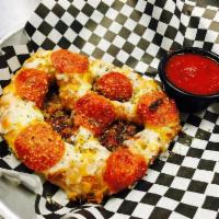 PEPPERONI PRETZEL · Giant german style pretzel with cheese and cupping pepperonis, served with ranch or red sauce