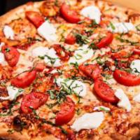 Margherita Pizza · Red sauce, fresh mozzarella, sliced tomatoes, extra virgin olive oil and fresh basil.