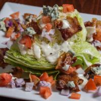 Classic Wedge Salad · A wedge of iceberg lettuce topped with imported crumble bleu cheese, crisp candied bacon, di...