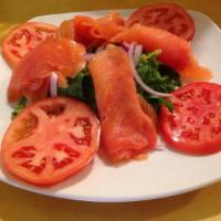 Smoked Salmon Plate · Mild smoked salmon over wild arugula, sliced fresh tomatoes, red onions, served with bagel a...