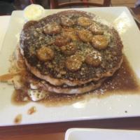 Banana Mama Pancakes · Sauteed bananas, walnuts in a brandy caramel sauce, topped over buttermilk pancakes and whip...