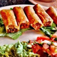 Taquitos el Charro · Four crispy mini beef taquitos served with guacamole and sour cream. Garnished with lettuce ...