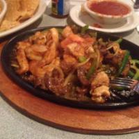 Combination Fajita · Steak and chicken. Marinated in a blend of spices, then grilled and served sizzling hot with...