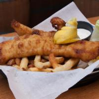 Fish and Chips · two beer battered white fish portions served over a bed of french fries with our housemade t...