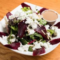 Roast Beet and Goats Cheese Salad · Roasted beet, goat cheese, and almonds, served over mixed greens.
