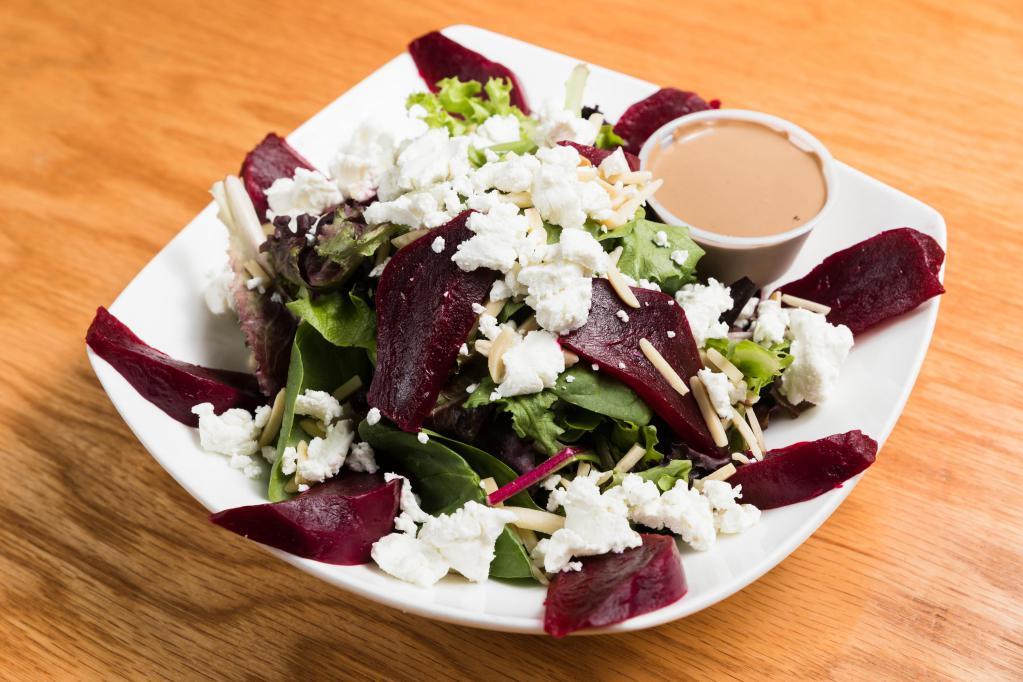 Roast Beet and Goats Cheese Salad · Roasted beet, goat cheese, and almonds, served over mixed greens.