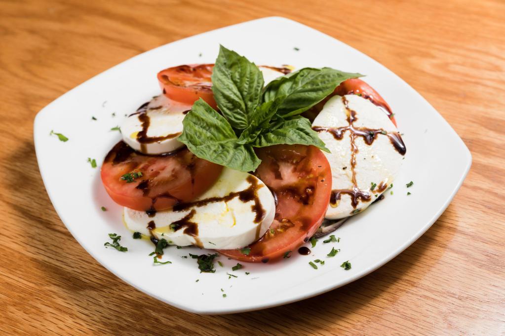 Fresh Mozzarella Caprese · Sliced fresh mozzarella cheese and seasoned tomatoes drizzled with basil extra virgin olive oil and balsamic reduction.