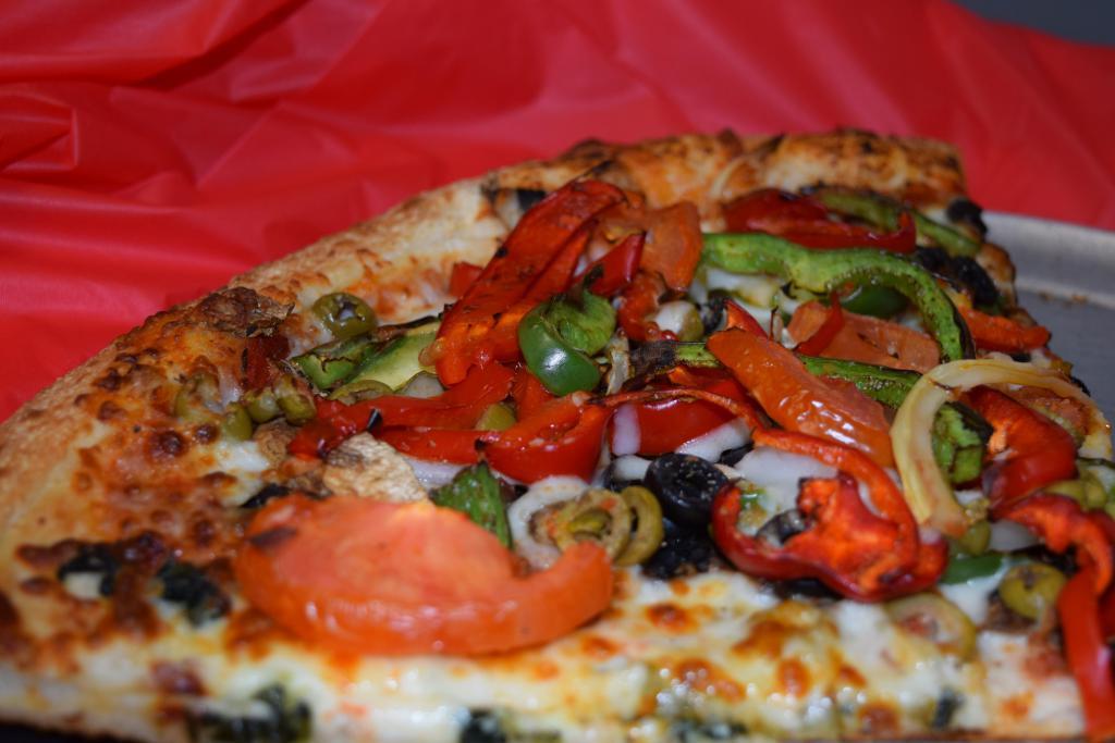 Veggie Pizza · Pizza sauce, mushrooms, onions, black and green olives, red and green bell peppers, fresh tomatoes.