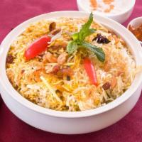 Chicken Biriyani · Aromatic basmati rice with ginger, garlic, nuts and raisin, served with pickle and raitha.