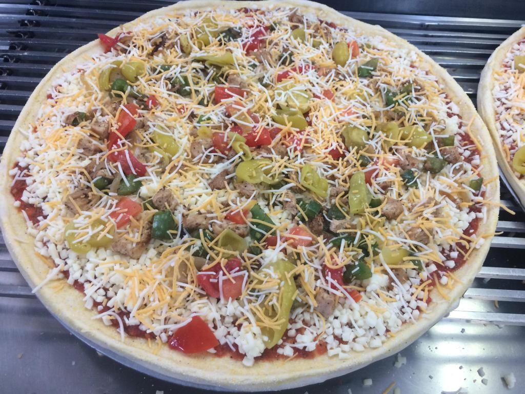 Chicken Fajita Pizza · Our original tomato sauce, mozzarella cheese, grilled marinated chicken breast, onions, green peppers, banana peppers and tomatoes. Topped with Monterey Jack and cheddar cheese.