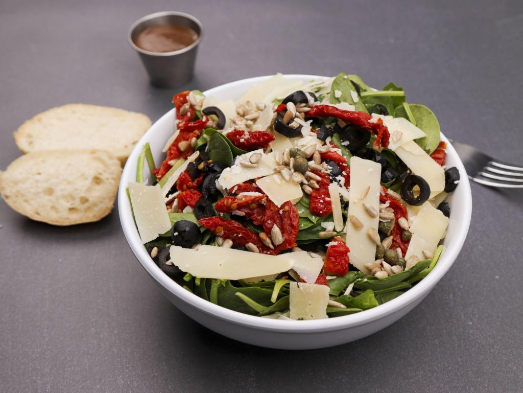 Spinach Salad · Spinach, sun-dried tomatoes, sunflower seeds, capers, olives and Parmesan. Served with choice of dressing and foccacia bread.