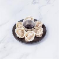 Steamed Dumplings · Steamed homemade dumplings filled with carrots, scallions, zucchini, and choice of beef or t...