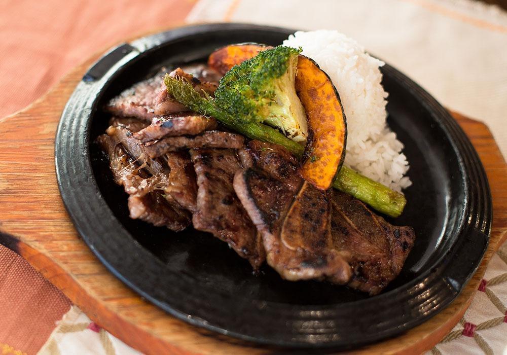 Kitchen Grilled Kalbi · Soy marinated short ribs served with grilled onion. Prepared in the kitchen and served with rice, grilled broccoli and kabocha squash. Gluten free.