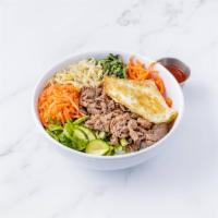 Hot Stone Beef Bibimbap · Rice topped with lettuce, carrots, zucchini, spinach, bean sprouts, spicy radish, fernbrake,...