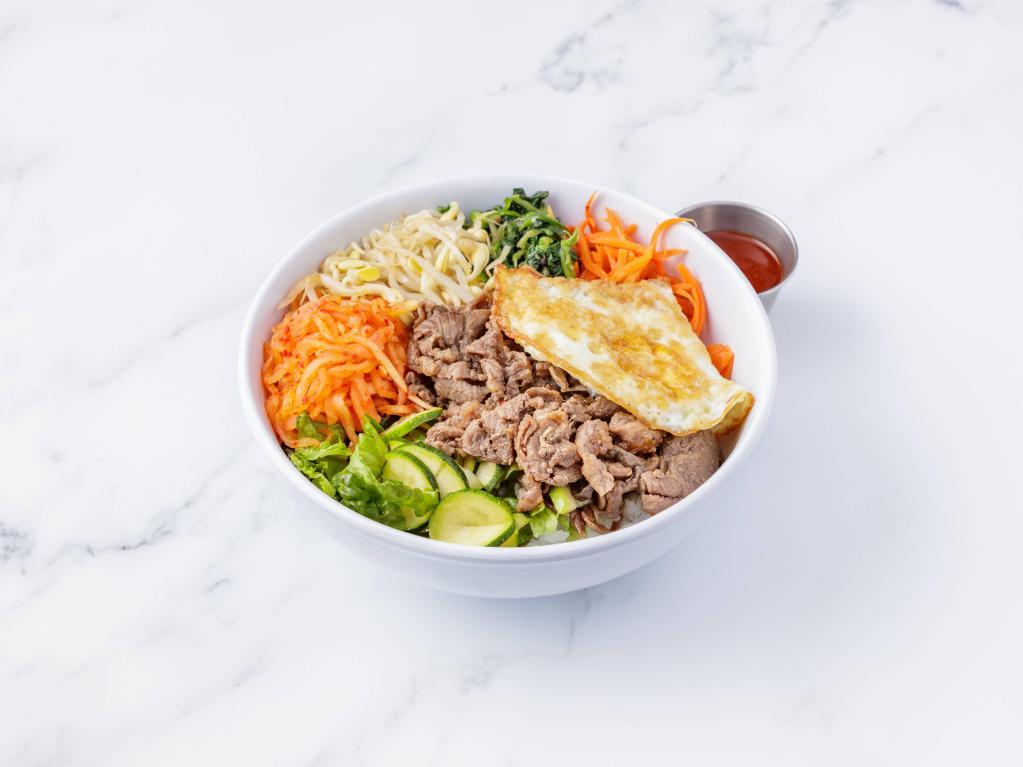 Hot Stone Beef Bibimbap · Rice topped with lettuce, carrots, zucchini, spinach, bean sprouts, spicy radish, fernbrake, egg. Served with chili sauce on the side. Gluten free.