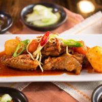 Spicy Braised Chicken · Chicken braised with potatoes, carrots, and bell peppers in spicy sauce, topped with scallio...