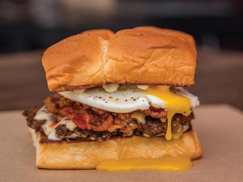 The Hangover  · White American cheese, smoked bacon, haus chili, fried egg, and mayo. Served on King's Hawaiian roll.