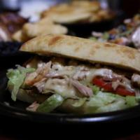Carali's Sandwich · Pulled rotisserie chicken, lettuce, tomato, mayonnaise and ciabatta bread. Served with choic...