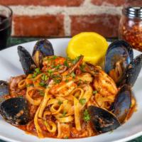 Fettuccini Pescatore · Calamari, prawns, mussels, clams and white onions tossed with your choice of tomato, pesto (...