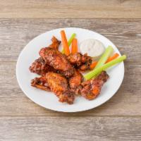 Famous Smoked Wings · Smoked then deep fried to crispy perfection.  Served naked or tossed in your choice of sauce.