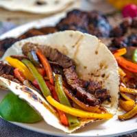 Grilled Fajita Taco · marinated Skirt Steak with fresh grilled bell peppers, sweet onions with our mild Red sause....
