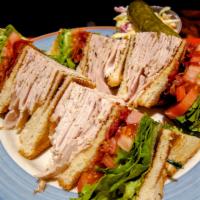 The Club House · Sliced Turkey, Ham, Bacon, lettuce, tomato, mayo, and cheese. Served with Choice of French F...