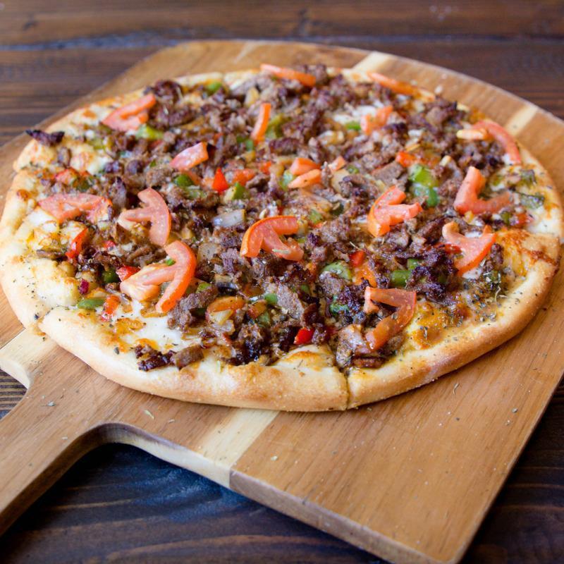 Philly Steak Pizza · Mixed blend cheese, Philly steak meat, sautéed onions, green bell pepper, and special house blend spices.