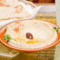 Hummus · A delicious Middle Eastern blend of garbanzo beans, tahini, fresh garlic, lemon and olive oi...