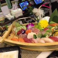 Lover Boat For 2 · 10 pieces of sushi, 18 pieces of sashimi and spider roll and rainbow roll. Comes with choice...