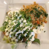 Tamales · 1 chicken and 1 poblano tamale. Topped with lettuce, salsa verde, sour cream and queso fresc...