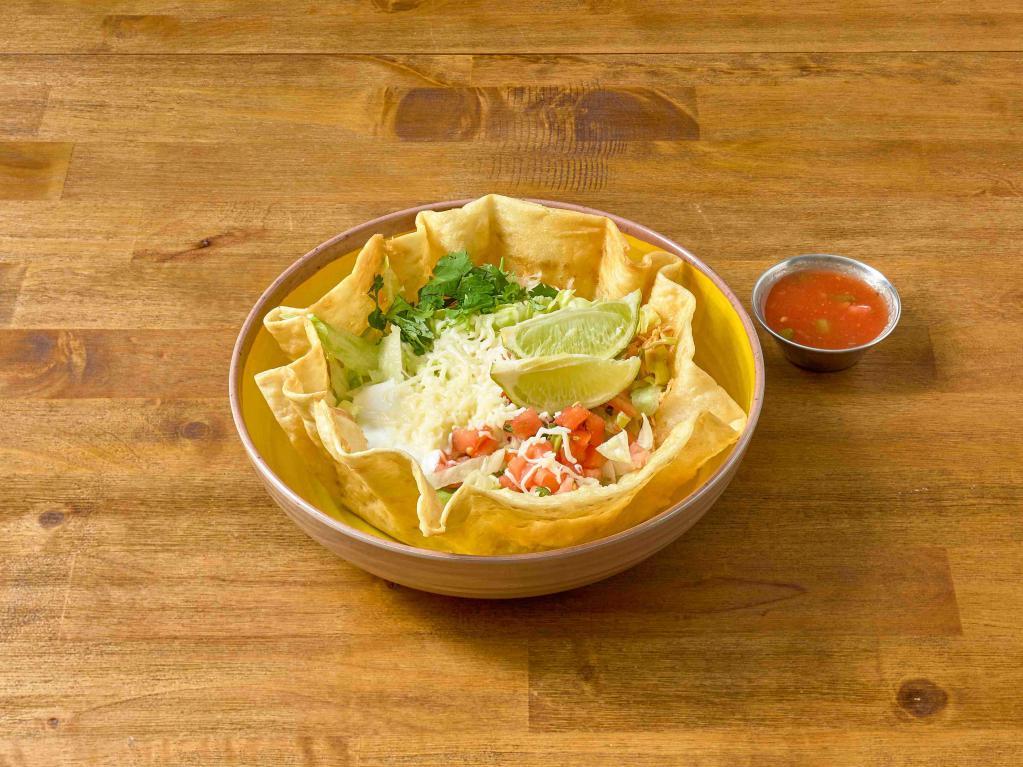 Tequila Taco Salad · A crispy tortilla bowl filled with crispy lettuce, refried beans, pico de gallo, sour cream, shredded cheese. Your choice of (picadillo) ground beef or shredded chicken. choice of dressing.
