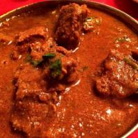48. Lamb Curry · Boneless lamb cooked in onion and tomato sauce with Himalayan herbs and spices.