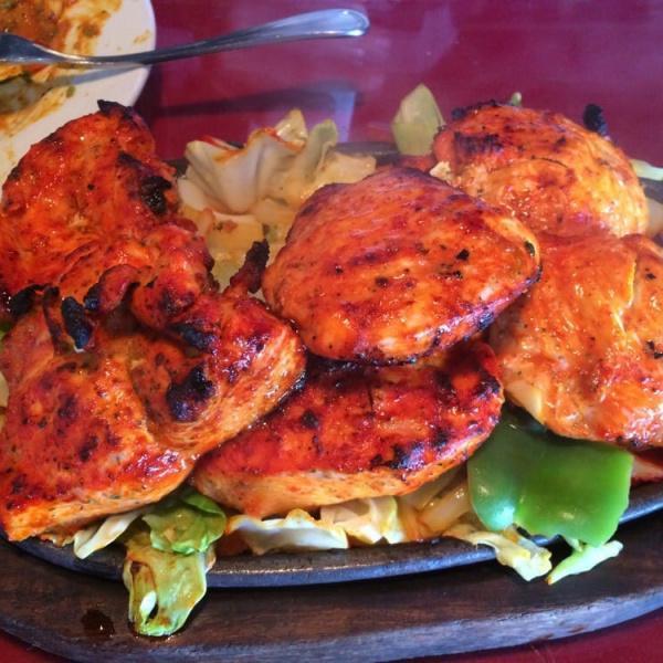 65. Chicken Tikka Tandoori · Boneless chicken breast marinated with Himalayan herbs and spices along with yogurt, then grilled in the tandoor oven and serve sizzling with sauteed onion, bell pepper, cabbage and carrot.