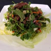 Beef Salad · Grilled beef, cucumber, tomatoes, onion, fresh mint and Thai sauce.