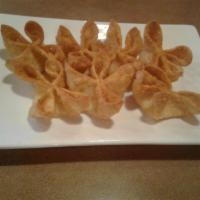 Crab Cheese Wontons · Crispy and deep fried wontons with a cream cheese and crab center.