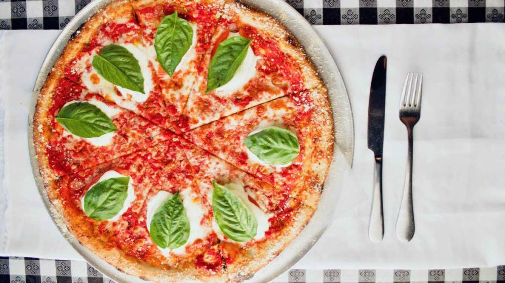 Margherita Pizza · Pizza sauce, Roma tomato, fresh mozzarella, basil, extra virgin olive oil. Made with homemade pizza sauce and dough.