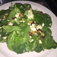 Baby Spinach Salad · Baby spinach, dried cranberries, walnuts and blue cheese crumbles tossed in our homemade hon...