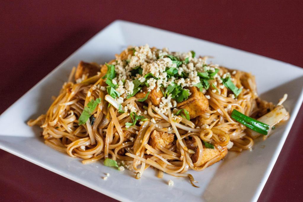 Pad Thai · Rice noodles, Thai sauce, egg, bean sprouts, yellow and green onions, peanuts, lime and cilantro. Spicy.