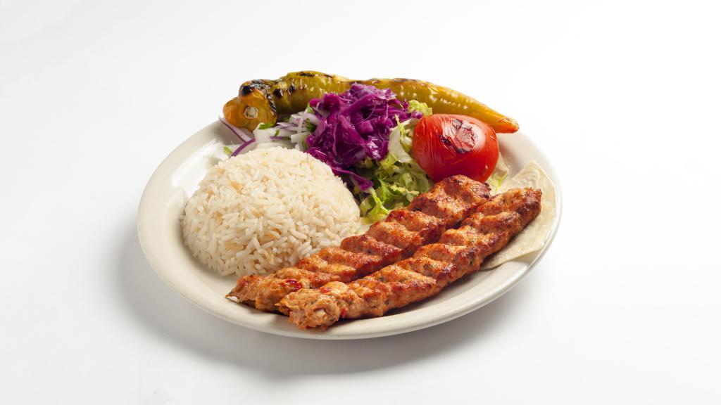 Chicken Adana · Chopped chicken flavored with fresh bell peppers, gently spiced paprika and char-grilled on a skewer. Served with rice and vegetables.