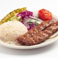 Adana Kebab · Hand-chopped lamb seasoned with spicy red peppers and char-grilled on skewers. Served with r...
