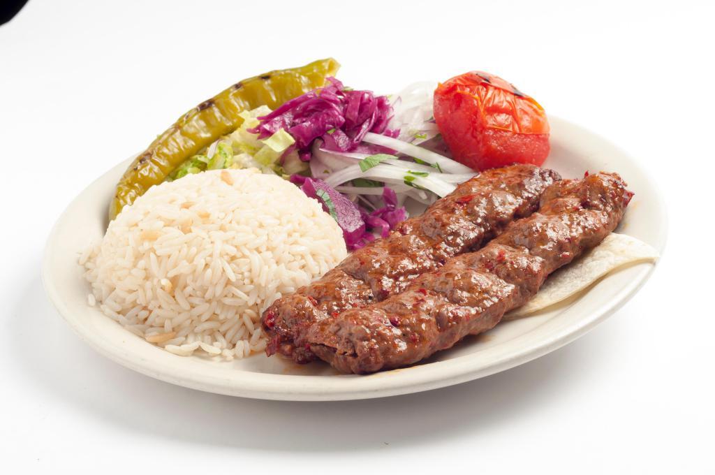 Adana Kebab · Hand-chopped lamb seasoned with spicy red peppers and char-grilled on skewers. Served with rice and vegetables.