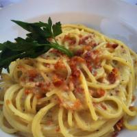 Spaghetti Carbonara · Served with crispy pancetta, egg yolk and Reggiano cheese.