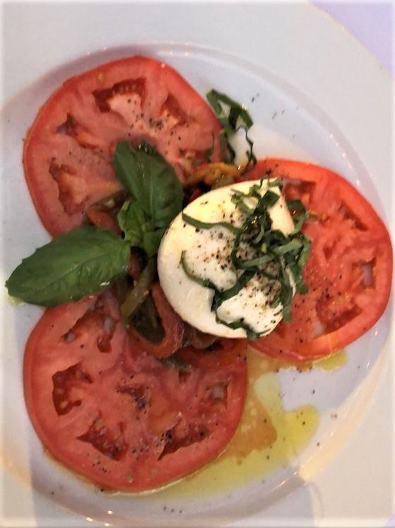 Caprese Salad · Fresh mozzarella with roasted bell peppers fresh tomatoes and basil.