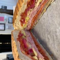 Salami Pepperoni Ham and Mozzarella Sandwich · Served with shredded lettuce, tomato pickled red onion and tapenade on focaccia. Served with...