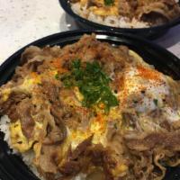 Gyudon Bowl · Sukiyaki beef with onions and eggs, served over rice and garnished with ginger and green oni...