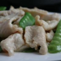 25. Chicken with Snow Peas · White meat chicken sauteed with snow peas, carrots, and white sauce. With a side of rice.